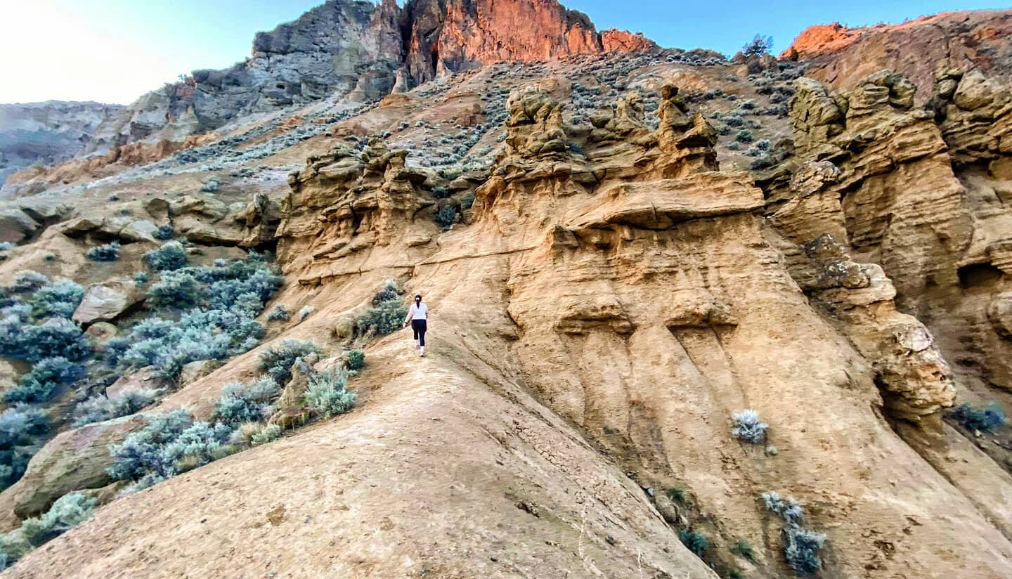 A hiker approaches the Cinnamon Ridge hoodoos, via a trail accessible off Ord Road in Kamloops BC.