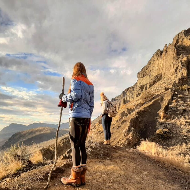 Two hikers pause on a hoodoo hike in Kamloops BC.