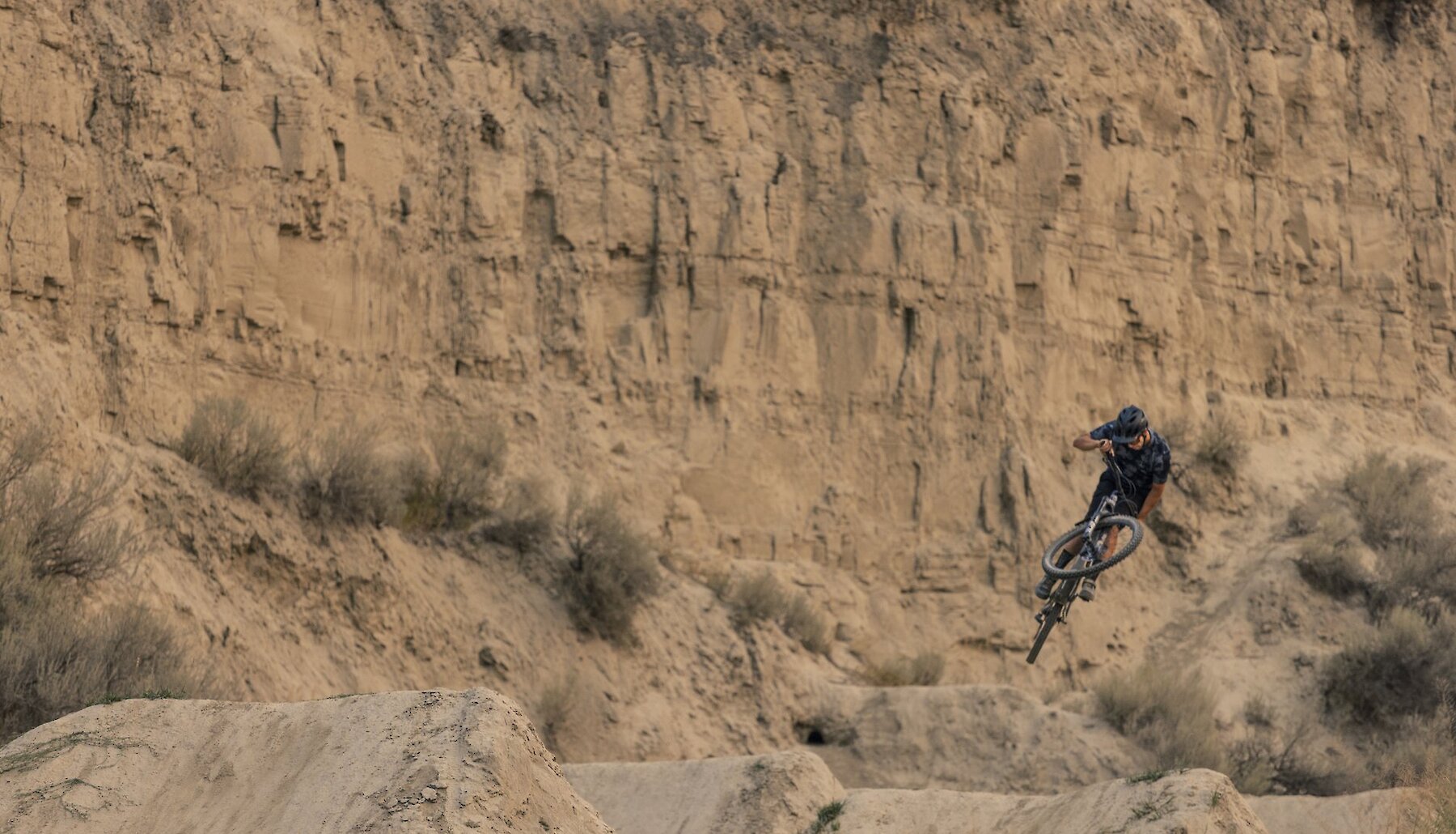 Mountain Bike Rider getting air in the jump park at the Kamloops Bike Ranch, located in the Thompson Valley, British Columbia.