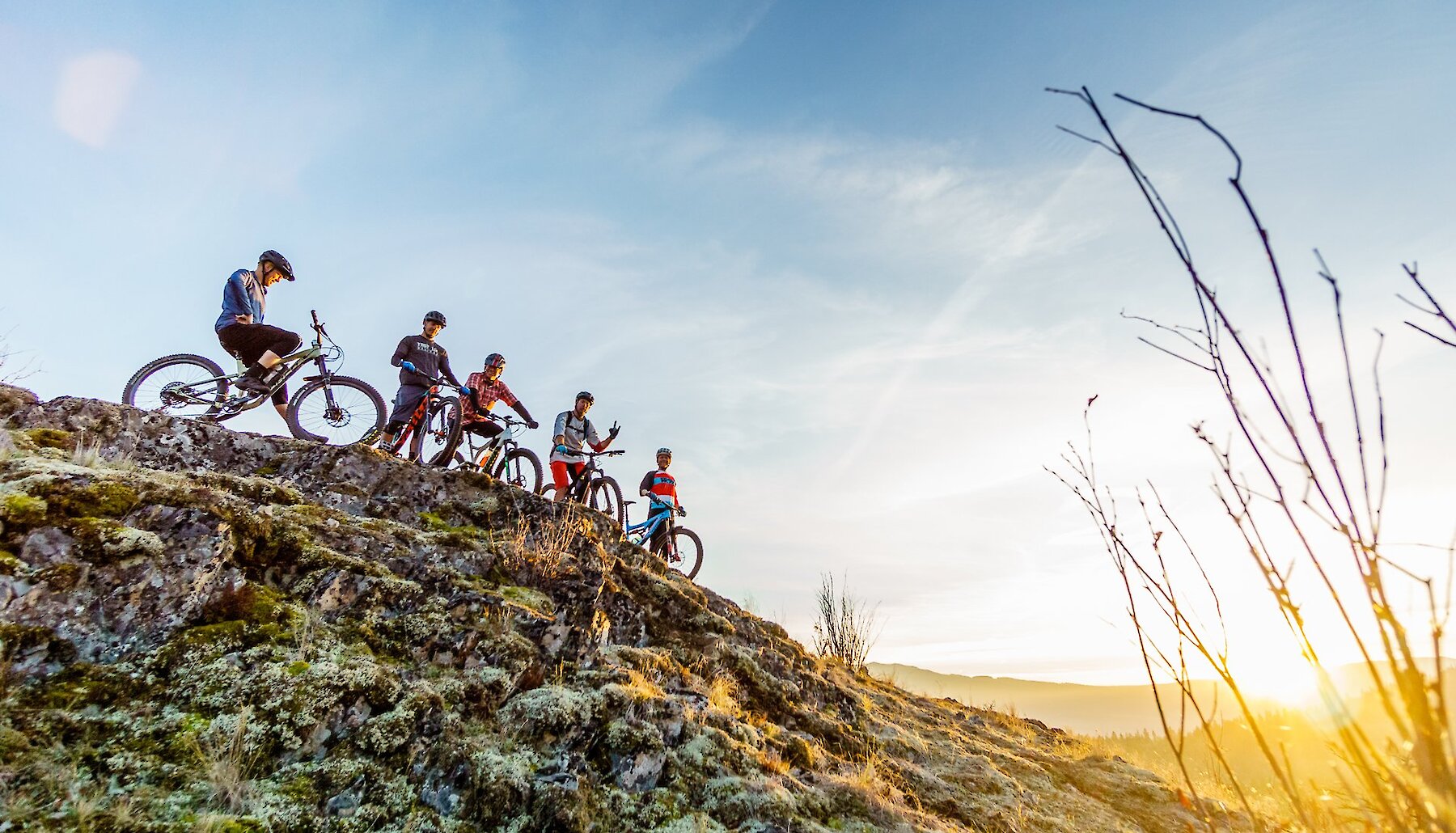 Group of mountain bikers ontop a hill in Pineview mountain biking network in Kamloops, BC.