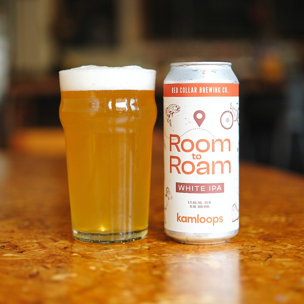 Pint of Room to Roam White IPA with a can beside it in the Red Collar Brewing Taproom located in Kamloops, BC.