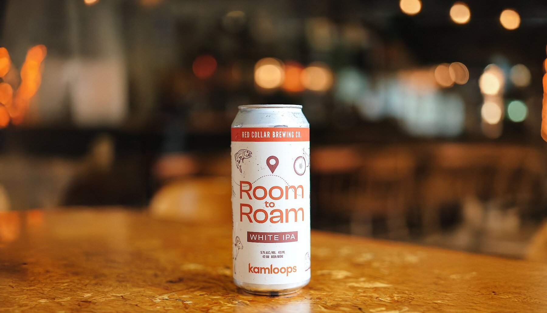 Tall beercan of the Room to Roam White IPA by Red Collar Brewing and Tourism Kamloops in the taproom at the brewery.