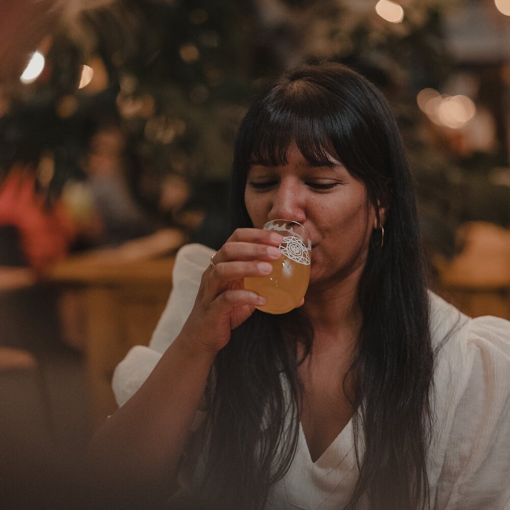 A woman sipping her beer at Bright Eye Brewing on the North Shore in Kamloops, British Columbia.