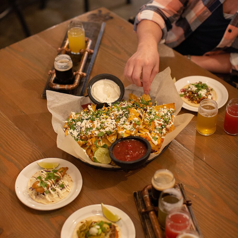 A big dish of nachos and craft beer flights from Iron Road Brewing in Kamloops, BC.