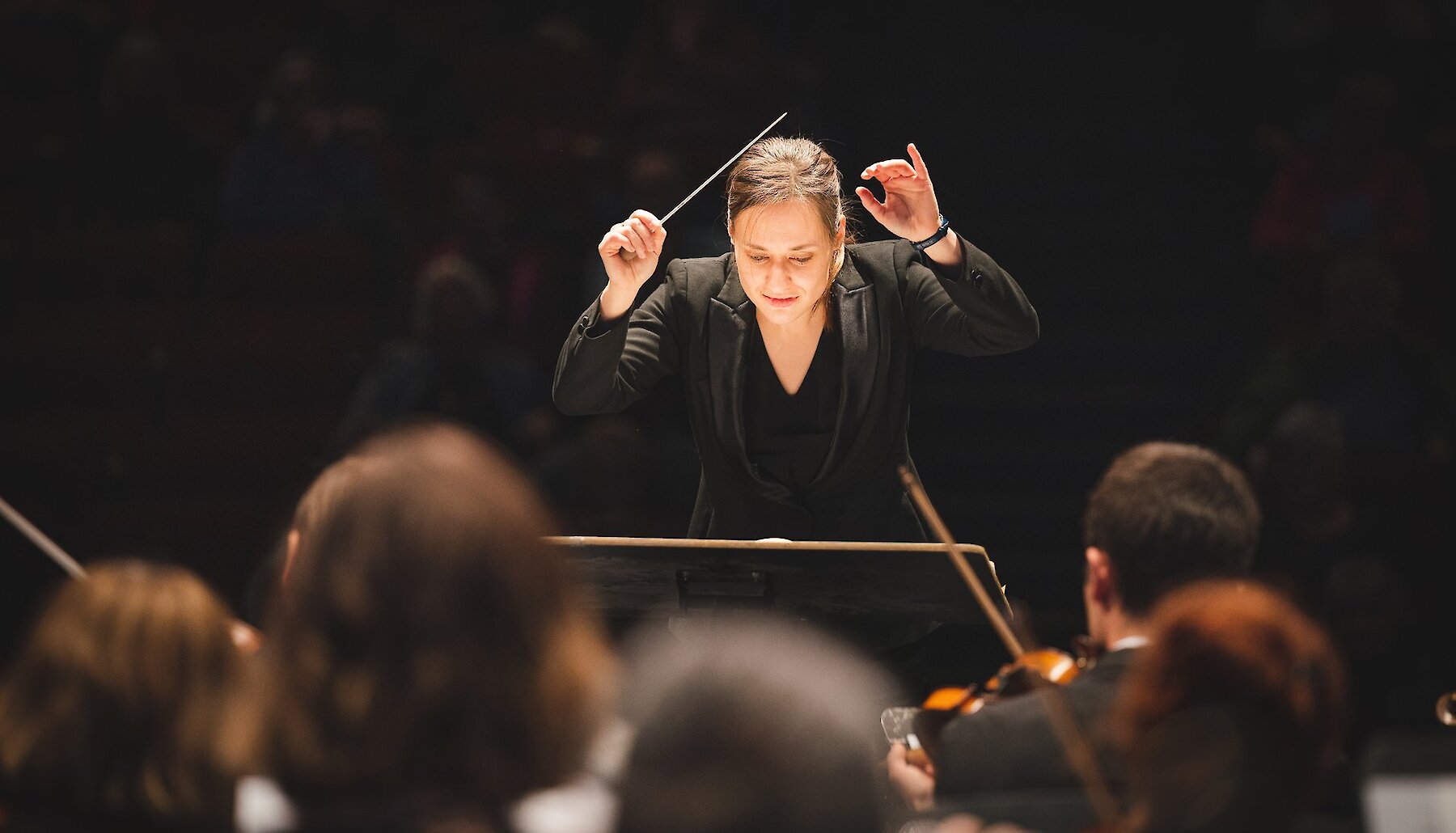 Conductor of the Kamloops Symphony Orchestra conducting the symphony in a performance at the Sagebrush Theatre in Kamloops, BC.