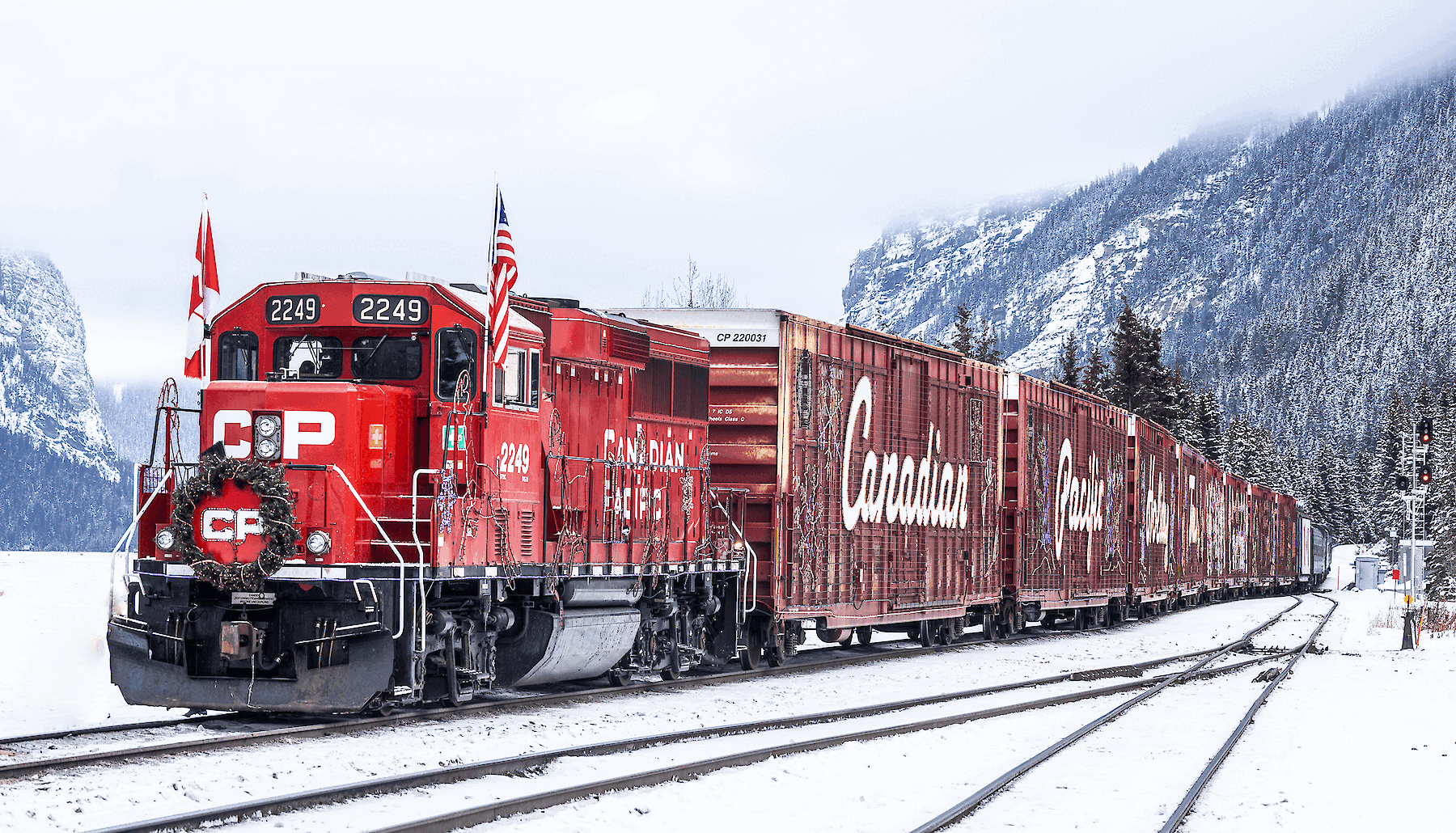 The festive Canadian Pacific Holiday Train travelling through a snowy Canadian winter landscape.