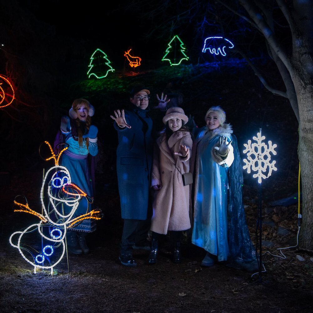 Visitors posing with Anna & Elsa from Frozen during Wildlights at the BC Wildife Park near Kamloops, BC.