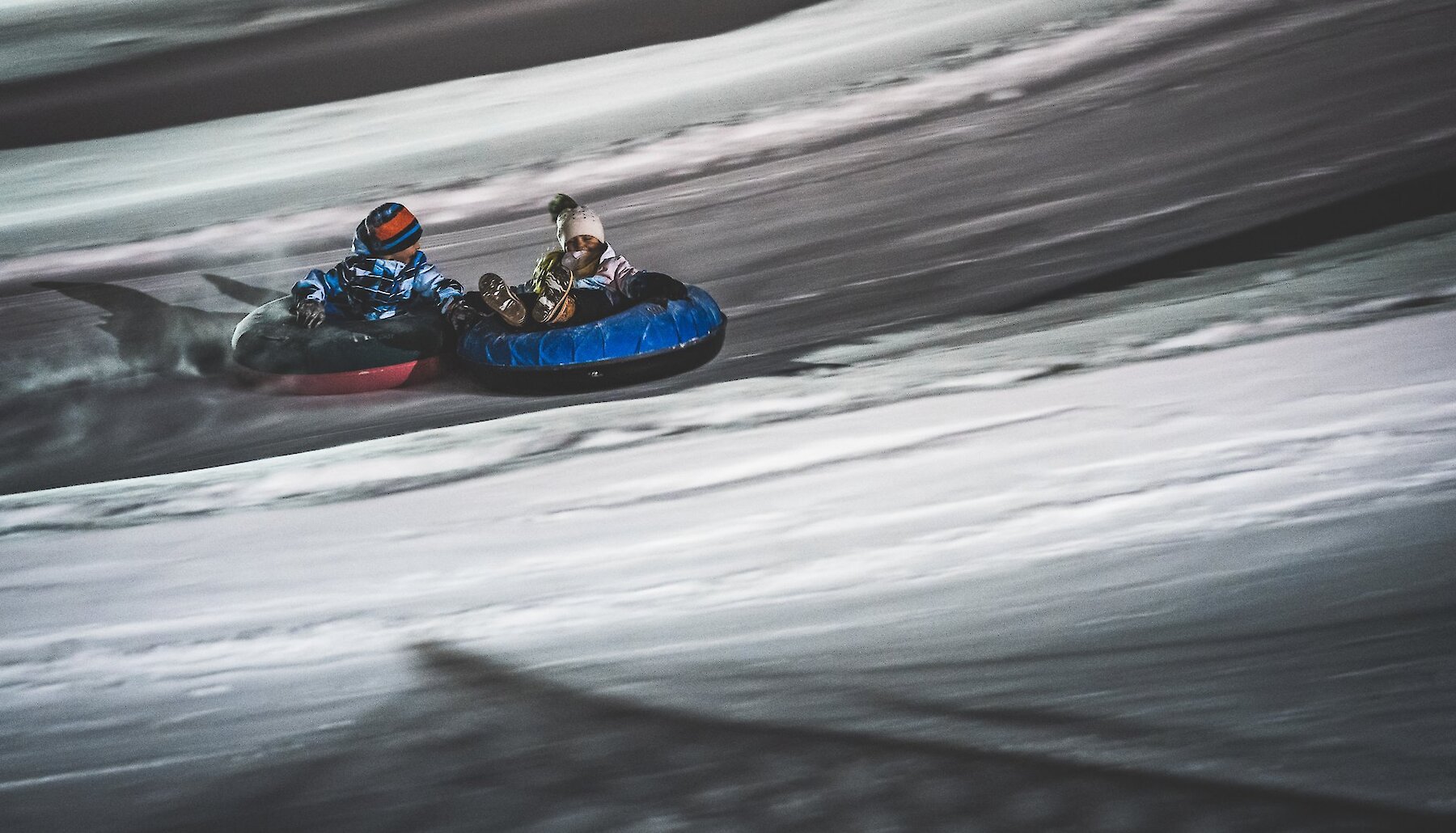 Kids tubing at the family friendly Harper Mountain Snow Town Tube Park near Kamloops, British Columbia.