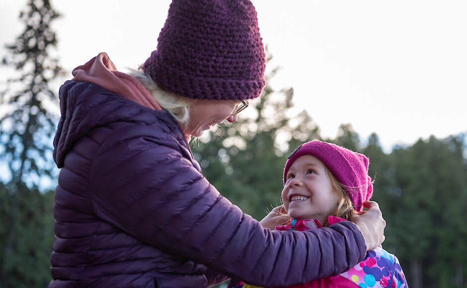 Mom helping her daughter put on her toque at Harper Mountain ski resort near Kamlooops, BC.