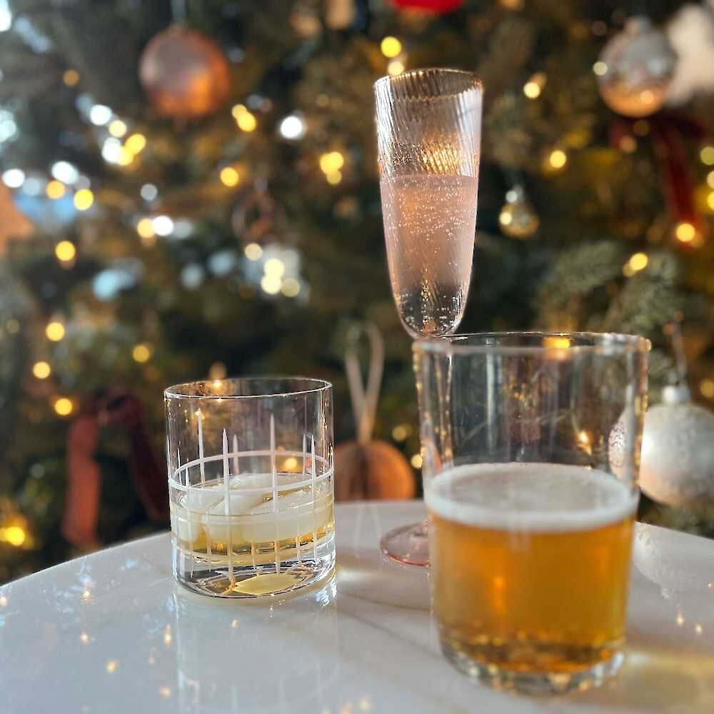 Festive cocktails in front of a Christmas Tree.