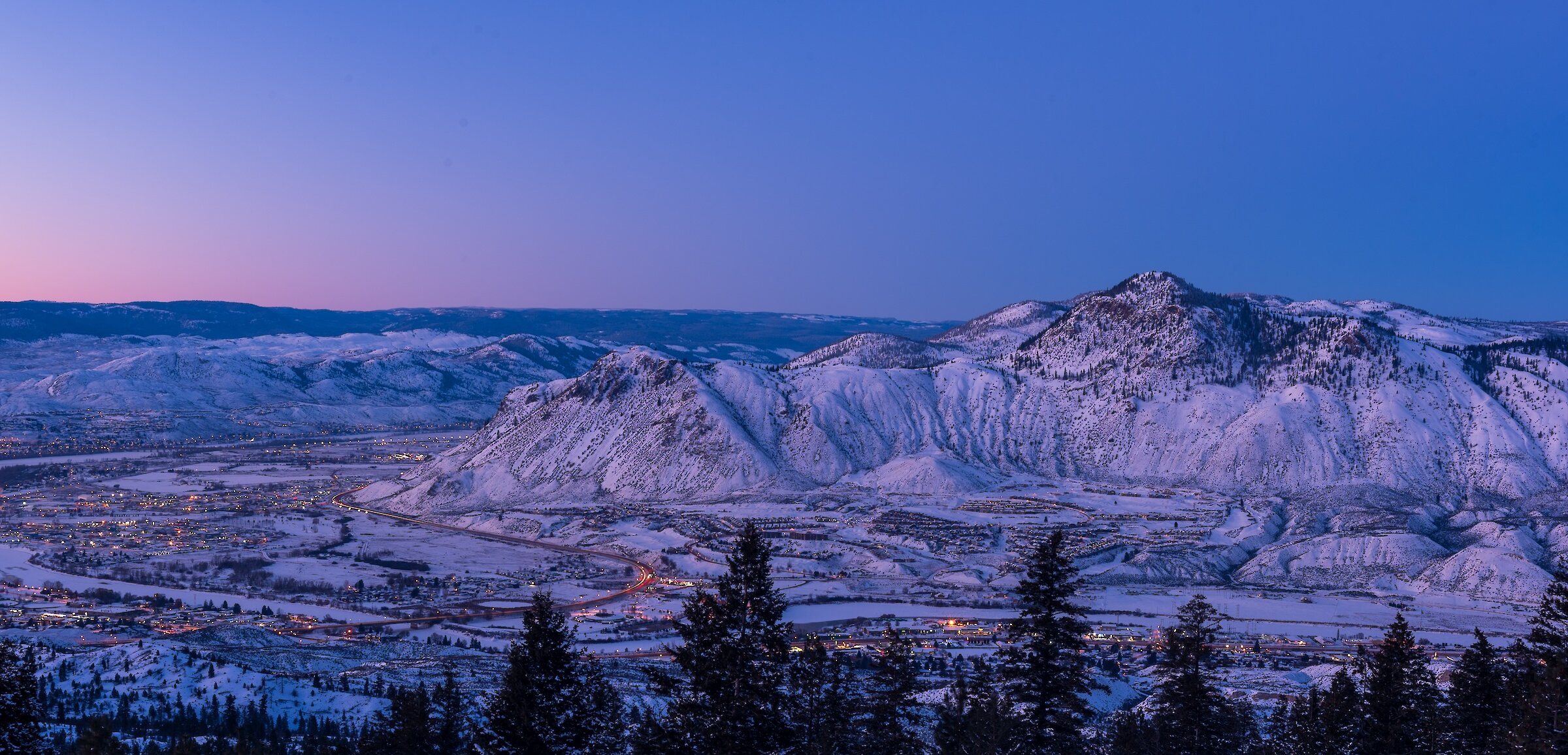 The colourful sunset over Kamloops with the snowy BC mountains in the background.