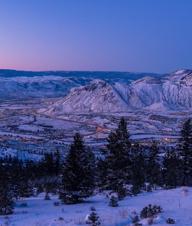 The colourful sunset over Kamloops with the snowy BC mountains in the background.