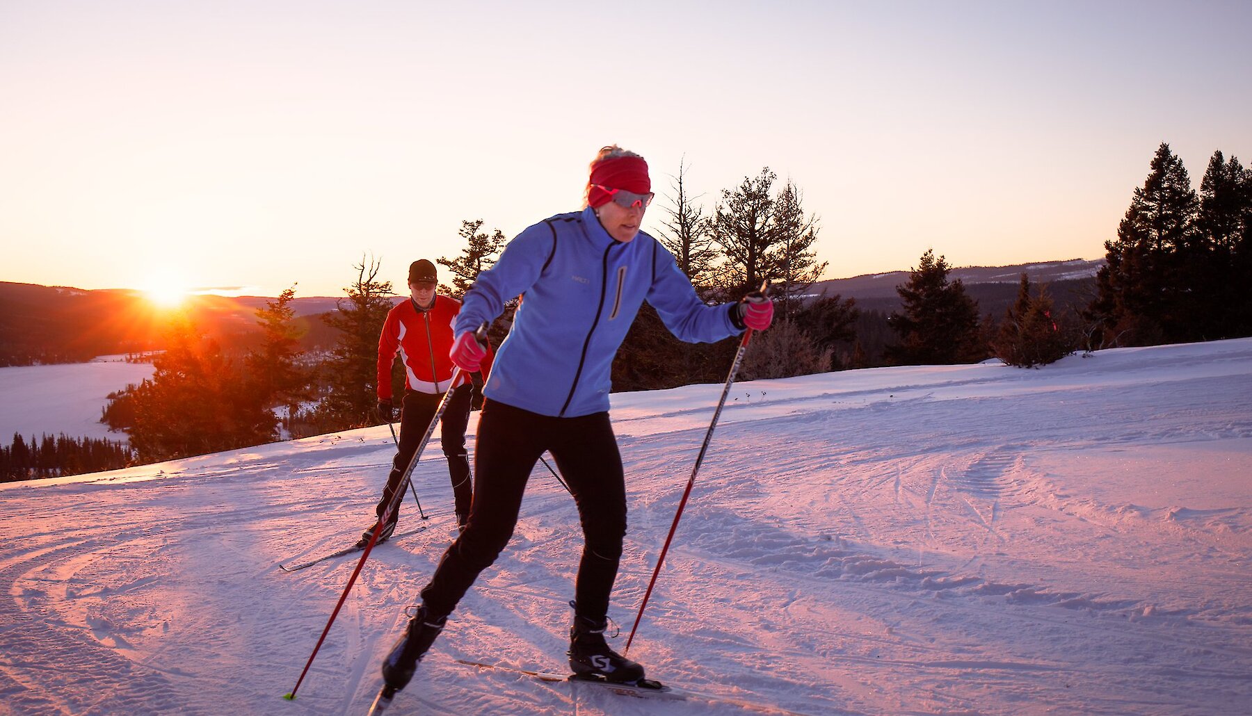 Two people cross-country ski at sunset near Stake Lake, outside of Kamloops BC.