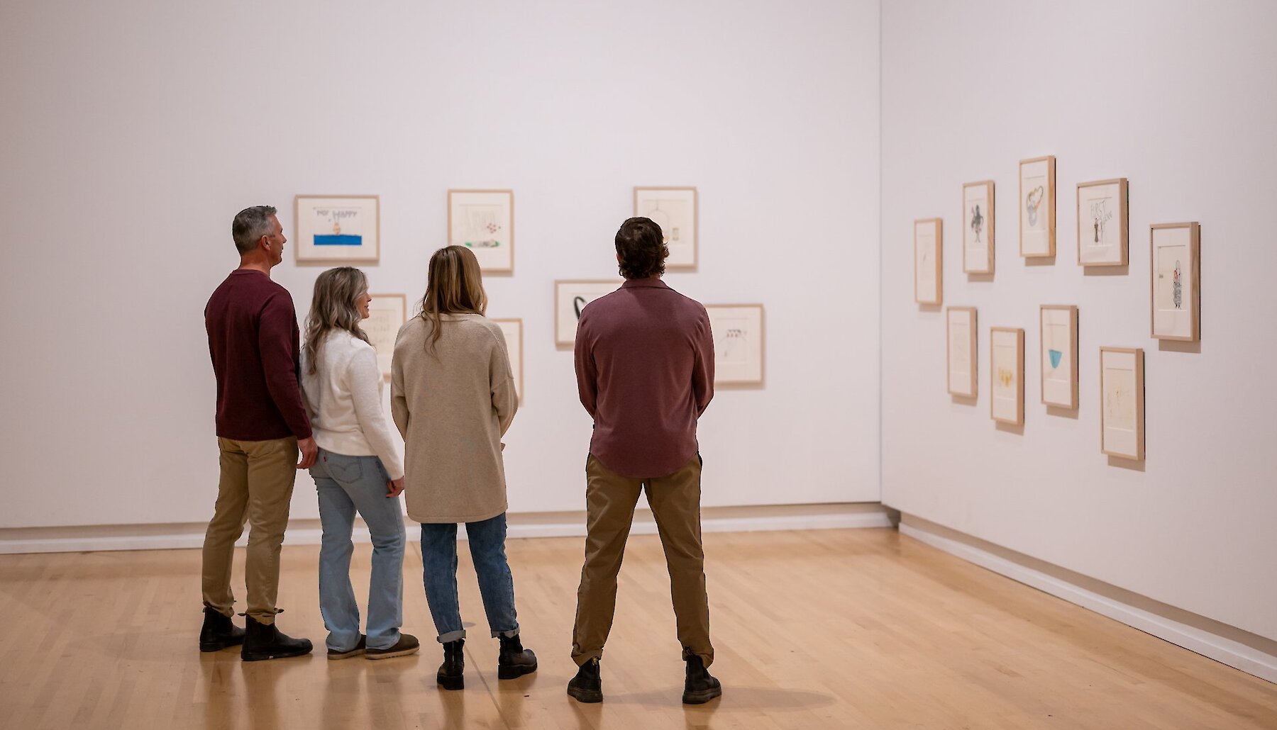 A group of people view displayed art at the Kamloops Art Gallery.