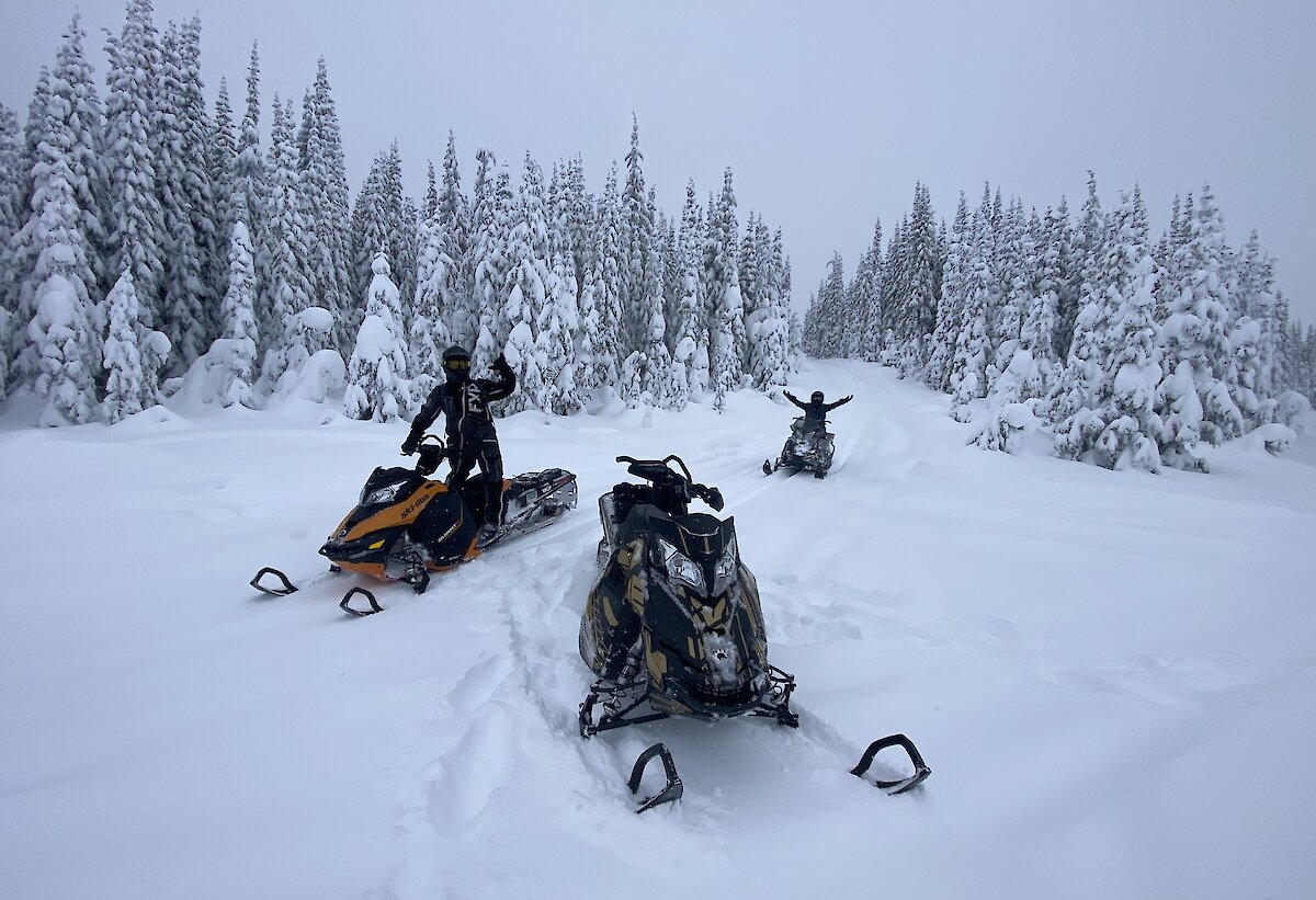 Kamloops Snowmobile Tours riding through the snow-covered trails in the Thompson Valley, BC.