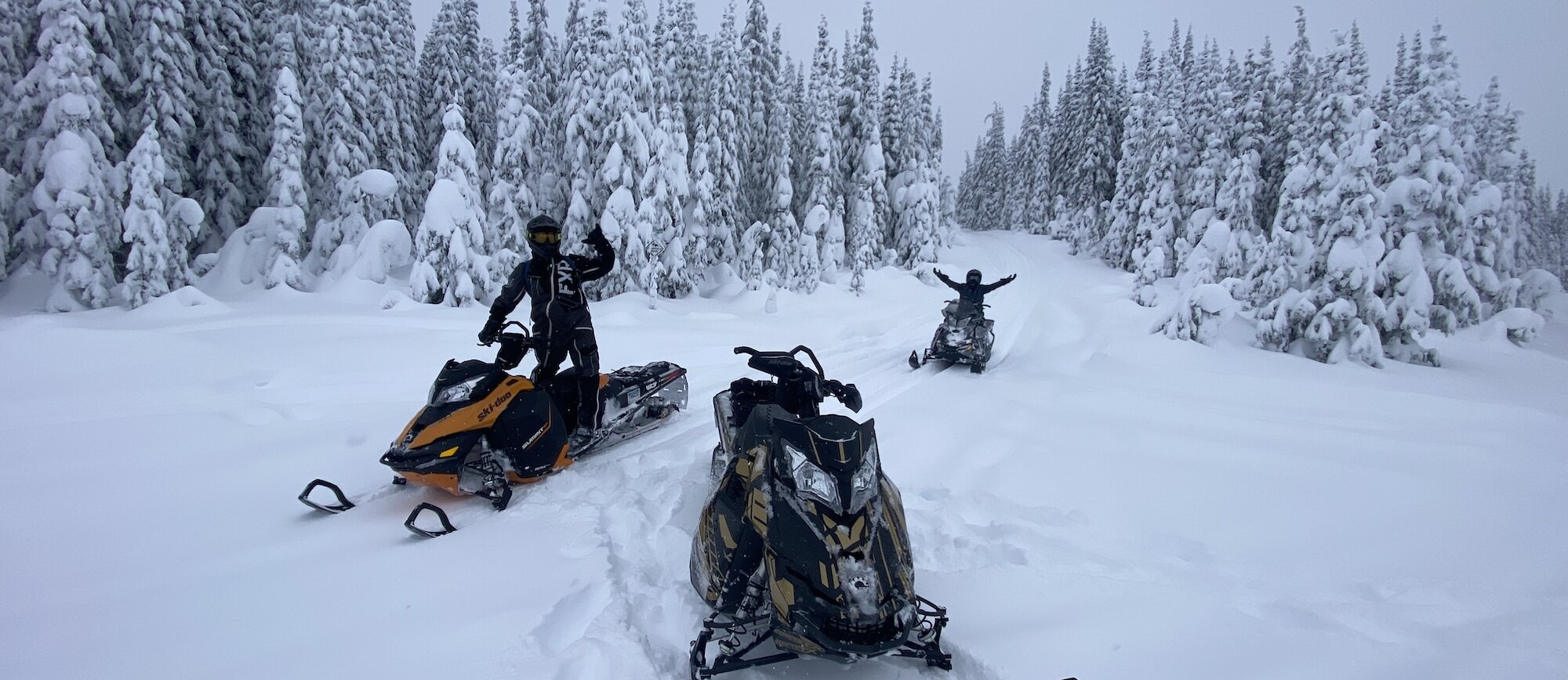 Kamloops Snowmobile Tours riding through the snow-covered trails in the Thompson Valley, BC.