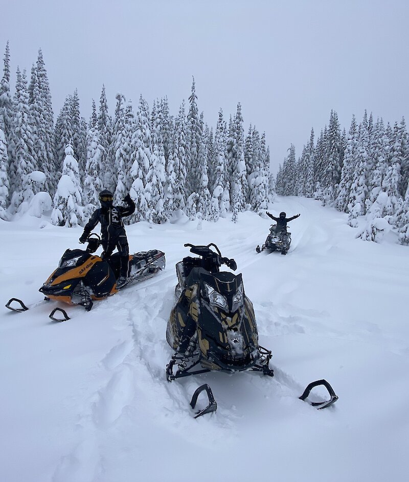 Kamloops Snowmobile Tours riding through the snow-covered trails in the Thompson Valley, BC.