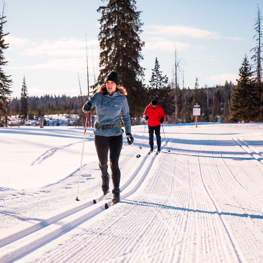 A couple cross-country skiing at Stake Lake Ski Trails with Overlander Ski Club.