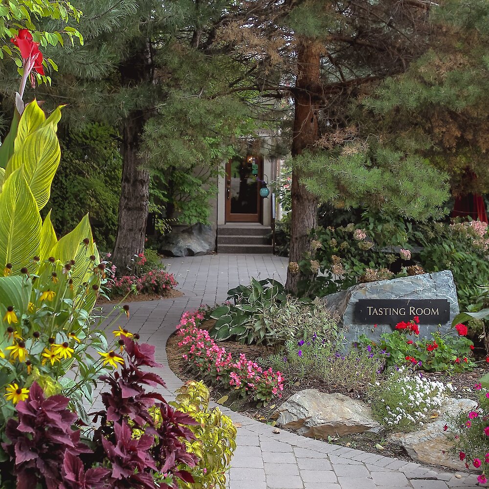 A lush garden path leads to the winery tasting room.