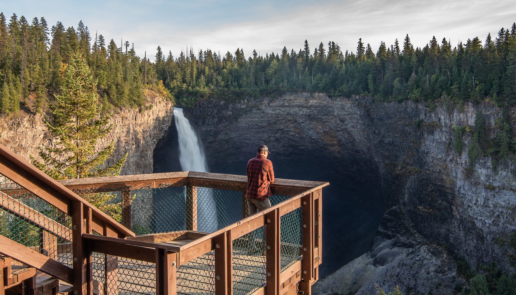 A man admires the iconic Helmcken Falls in Wells Gray Provincial Park, BC.