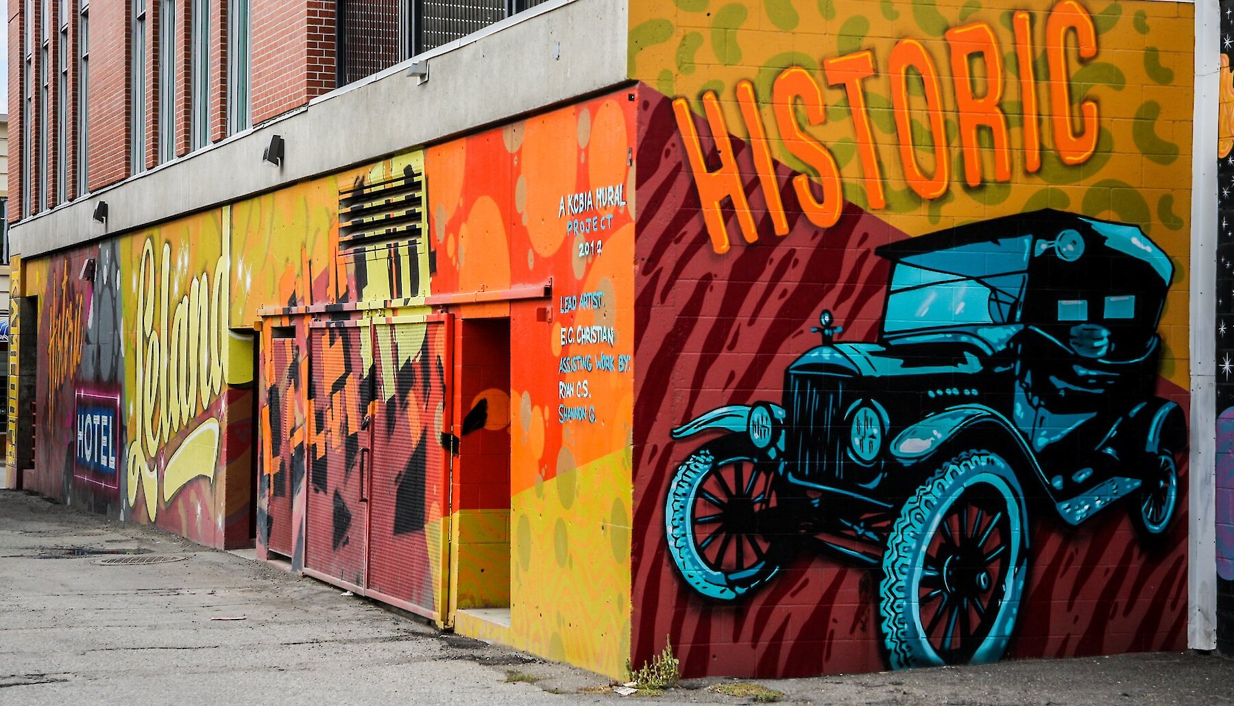 A brightly painted pop-art mural prominently featuring a Model T Ford and the word "Historic."