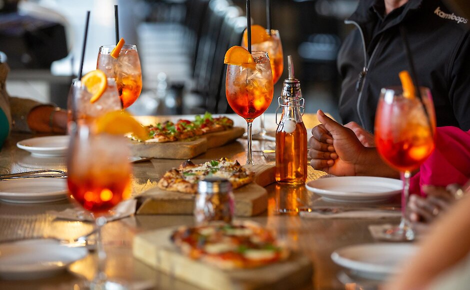 Flatbread pizzas and cocktails on the table at the Underbelly by the Pig in downtown Kamloops.